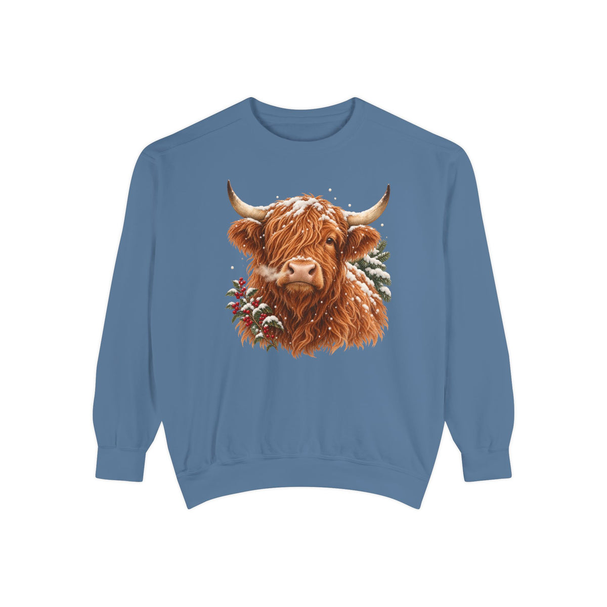 Highland cow sweatshirt in Blue Jean – a shaggy ginger Highland cow with snow on its fringe, a snowy pine bough and red berries, painted vintage-poster style, printed large on the chest of a Comfort Colors crewneck