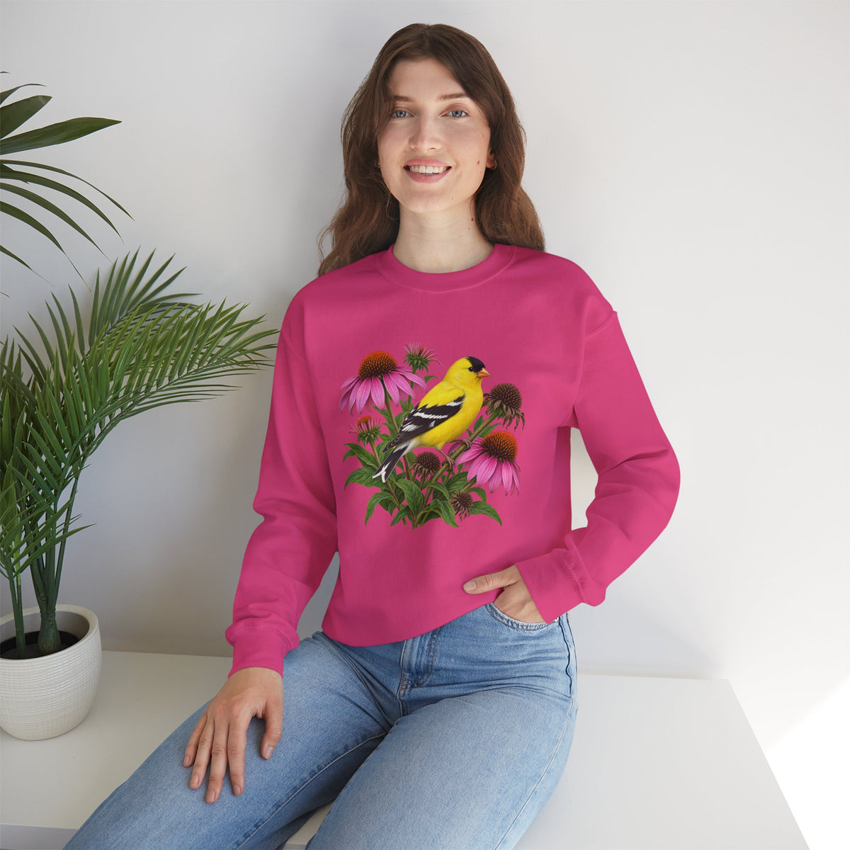 A Small Bright Thing crewneck sweatshirt, a golden-yellow American goldfinch among pink coneflowers, seed heads and green leaves, image 13 of 22