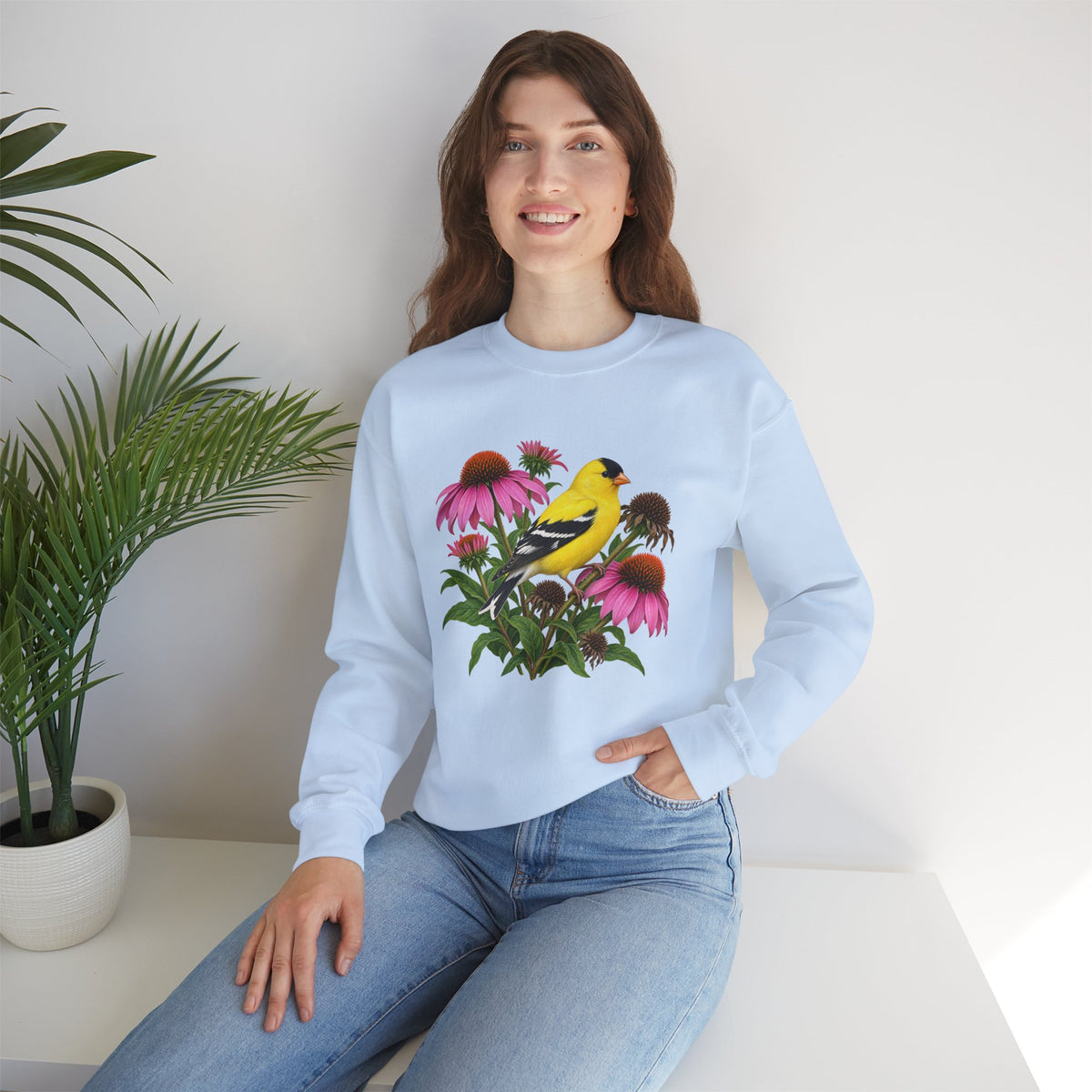 A Small Bright Thing crewneck sweatshirt, a golden-yellow American goldfinch among pink coneflowers, seed heads and green leaves, image 18 of 22