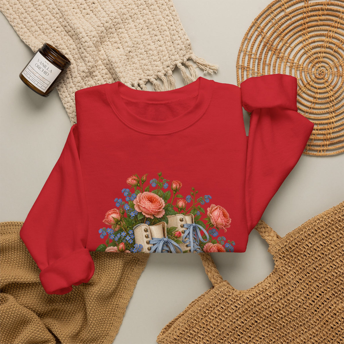 She Still Rolls crewneck sweatshirt, cream roller skates with blue laces and dusty pink wheels among coral roses, small blue flowers and trailing greenery, image 12 of 21