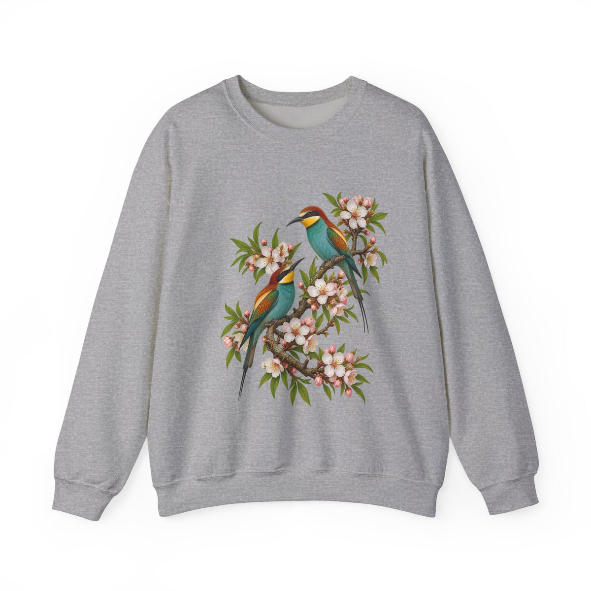 The Scenic Way Home sweatshirt — two birds with teal, golden-yellow and rust plumage perched among cream and blush blossoms, on a unisex crewneck