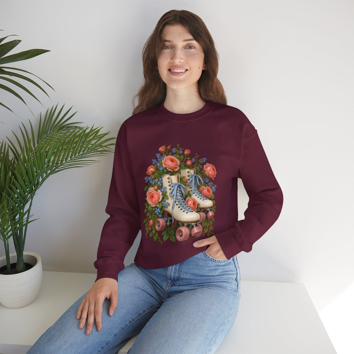 She Still Rolls crewneck sweatshirt, cream roller skates with blue laces and dusty pink wheels among coral roses, small blue flowers and trailing greenery, image 11 of 21
