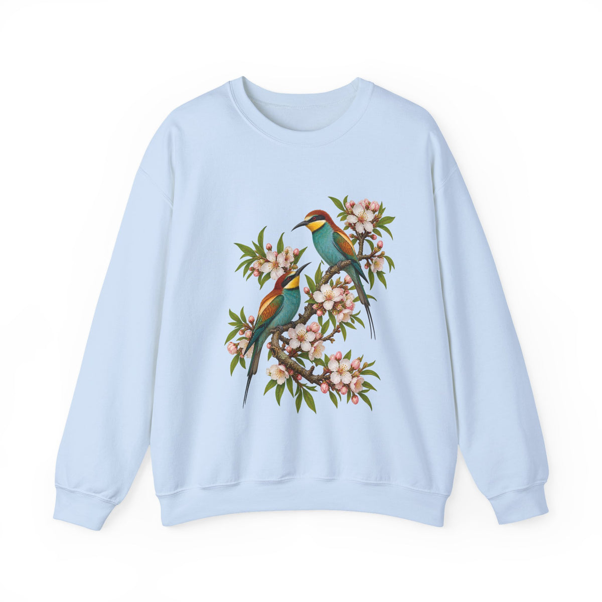 The Scenic Way Home sweatshirt — two birds with teal, golden-yellow and rust plumage perched among cream and blush blossoms, on a unisex crewneck