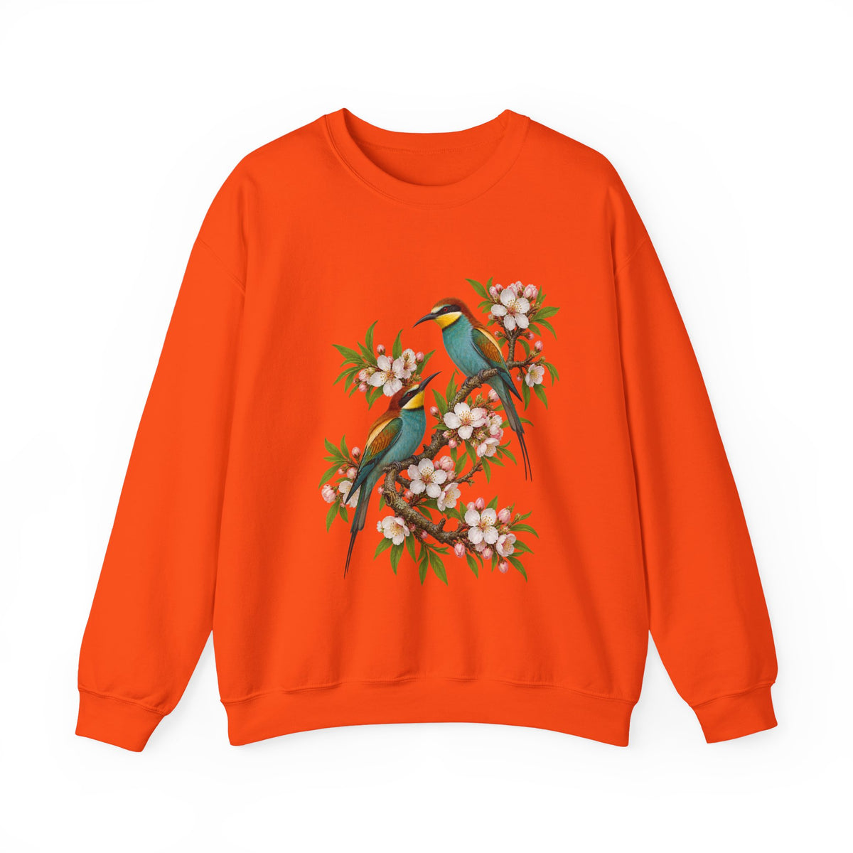 The Scenic Way Home sweatshirt — two birds with teal, golden-yellow and rust plumage perched among cream and blush blossoms, on a unisex crewneck