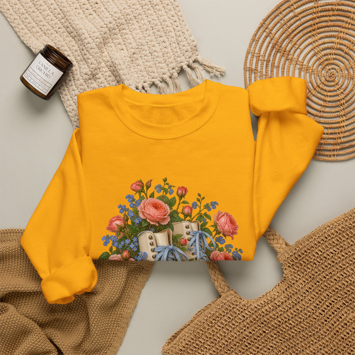She Still Rolls crewneck sweatshirt, cream roller skates with blue laces and dusty pink wheels among coral roses, small blue flowers and trailing greenery, image 14 of 21