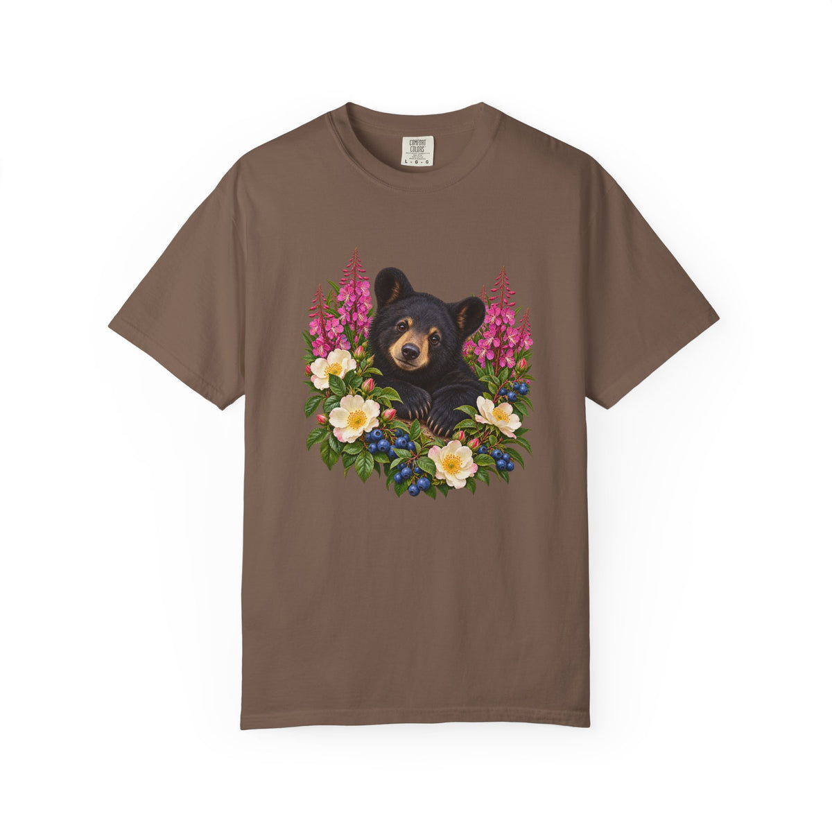 Tall magenta fireweed spikes, white wild roses and ripe blueberries around a young black bear, on a Comfort Colors garment-dyed tee