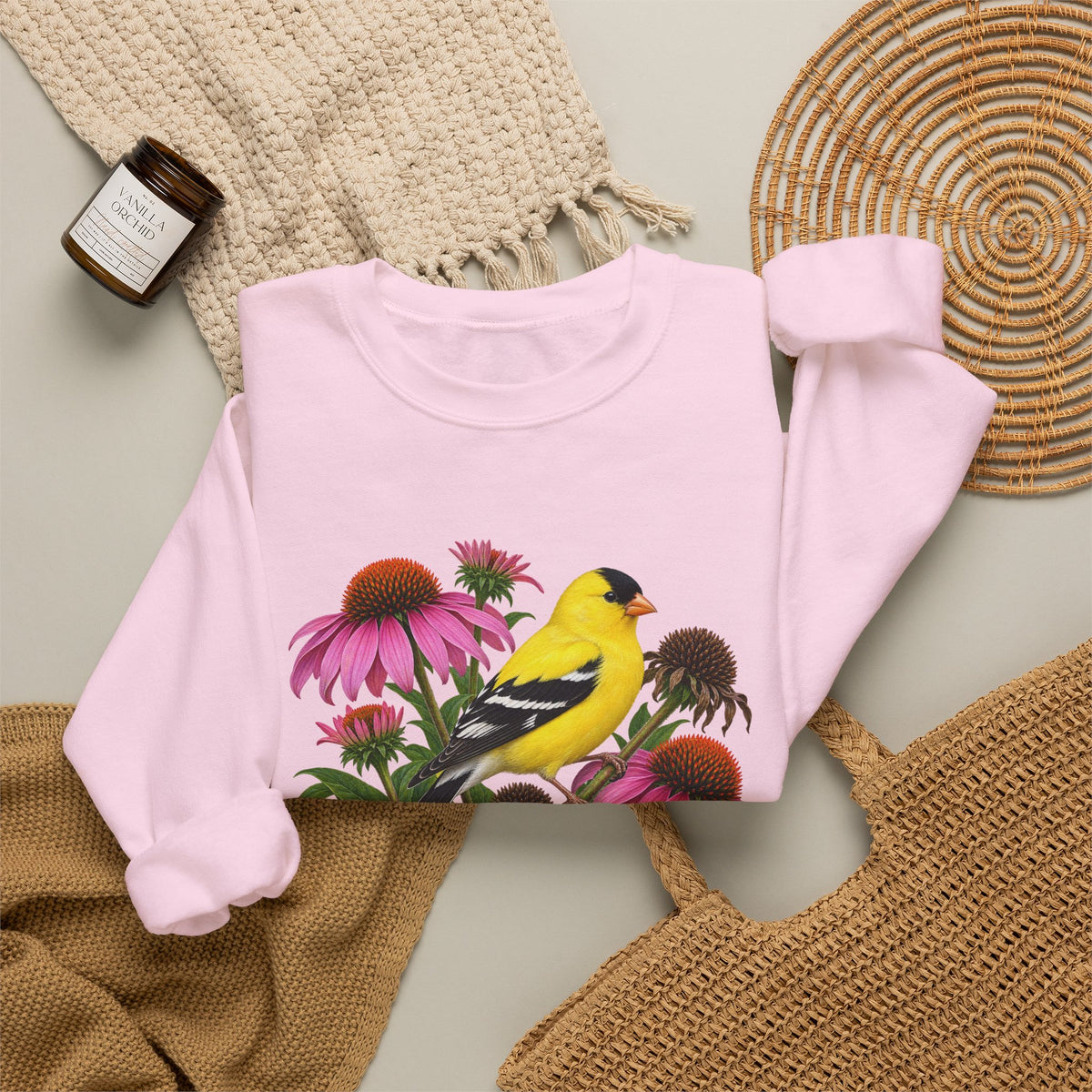 A Small Bright Thing crewneck sweatshirt, a golden-yellow American goldfinch among pink coneflowers, seed heads and green leaves, image 20 of 22