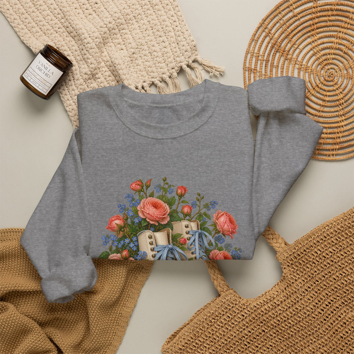 She Still Rolls crewneck sweatshirt, cream roller skates with blue laces and dusty pink wheels among coral roses, small blue flowers and trailing greenery, image 19 of 21