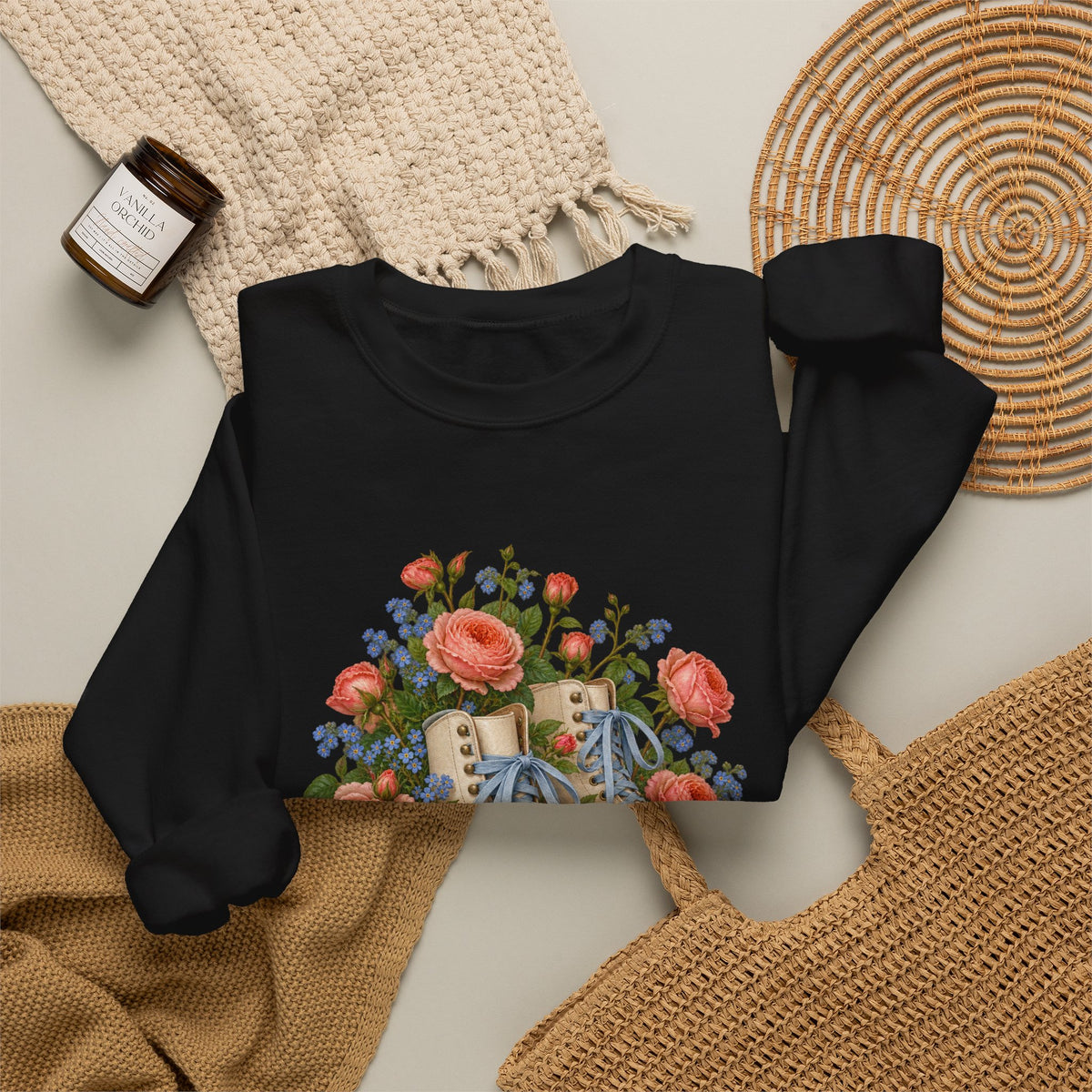 She Still Rolls crewneck sweatshirt, cream roller skates with blue laces and dusty pink wheels among coral roses, small blue flowers and trailing greenery, image 8 of 21