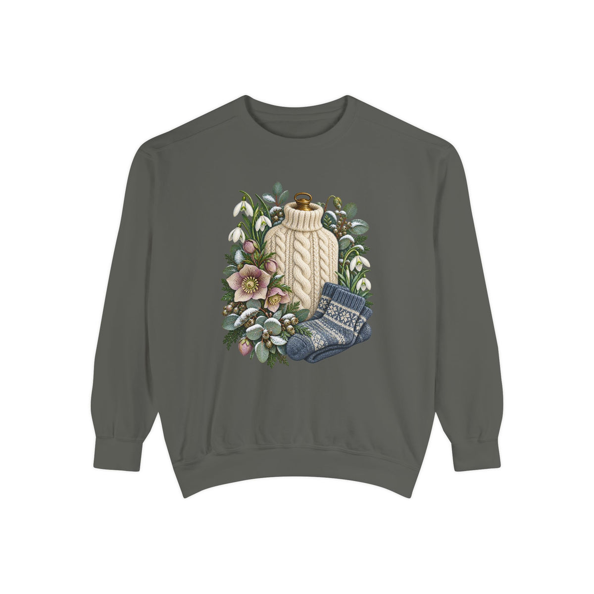 Botanical winter still life printed straight onto the garment color with no panel behind the artwork - a cream cable-knit bottle cover standing among white snowdrops, pink hellebores, folded blue patterned socks and snow-dusted evergreen
