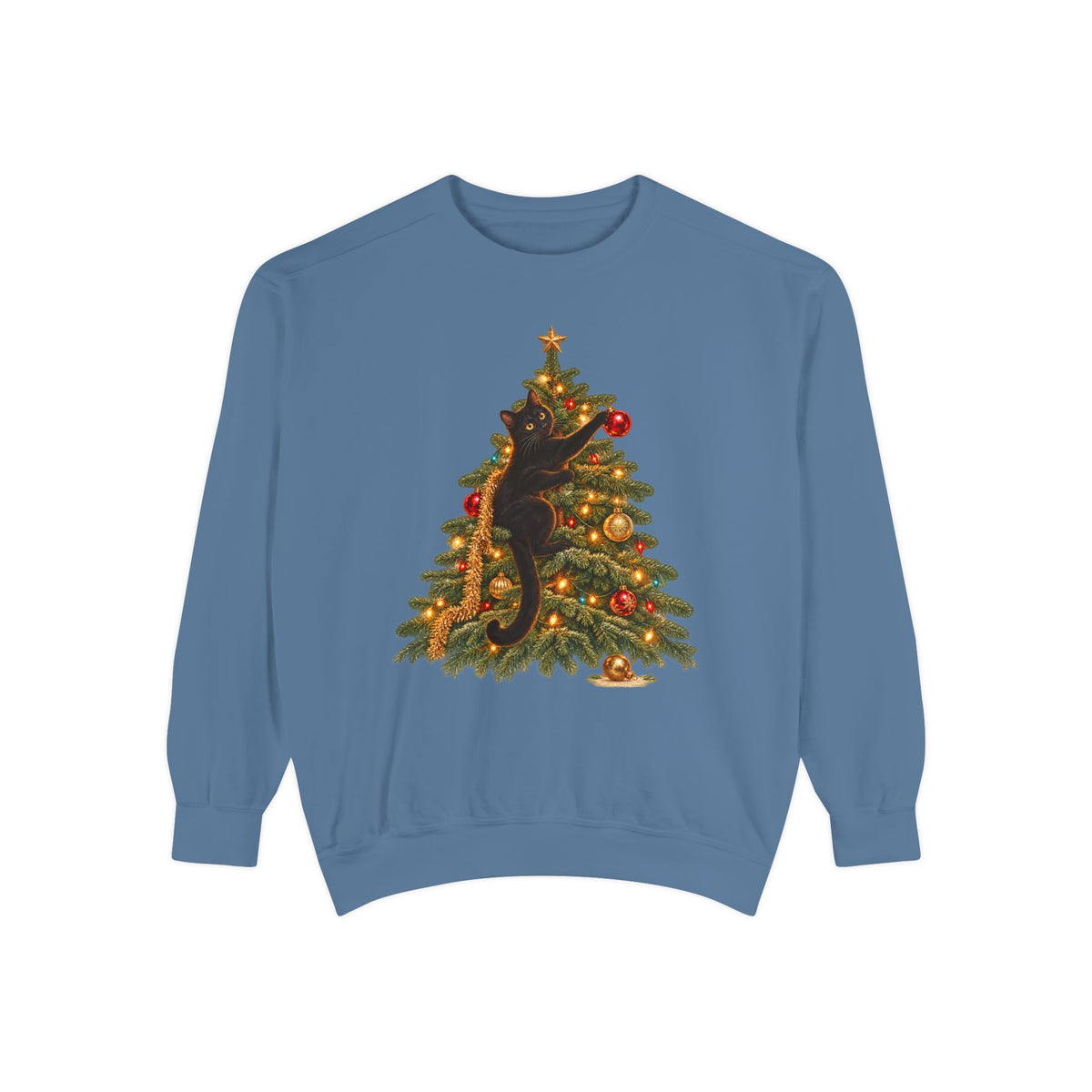 Black cat Christmas sweatshirt in Blue Jean – a black cat climbing a lit Christmas tree with a gold star, one paw on a red ornament, printed large on the chest of a Comfort Colors crewneck