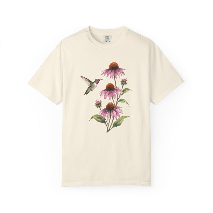 Hummingbird and Coneflowers tee — a broad-tailed hummingbird holding still beside a stand of purple coneflowers on garment-dyed cotton