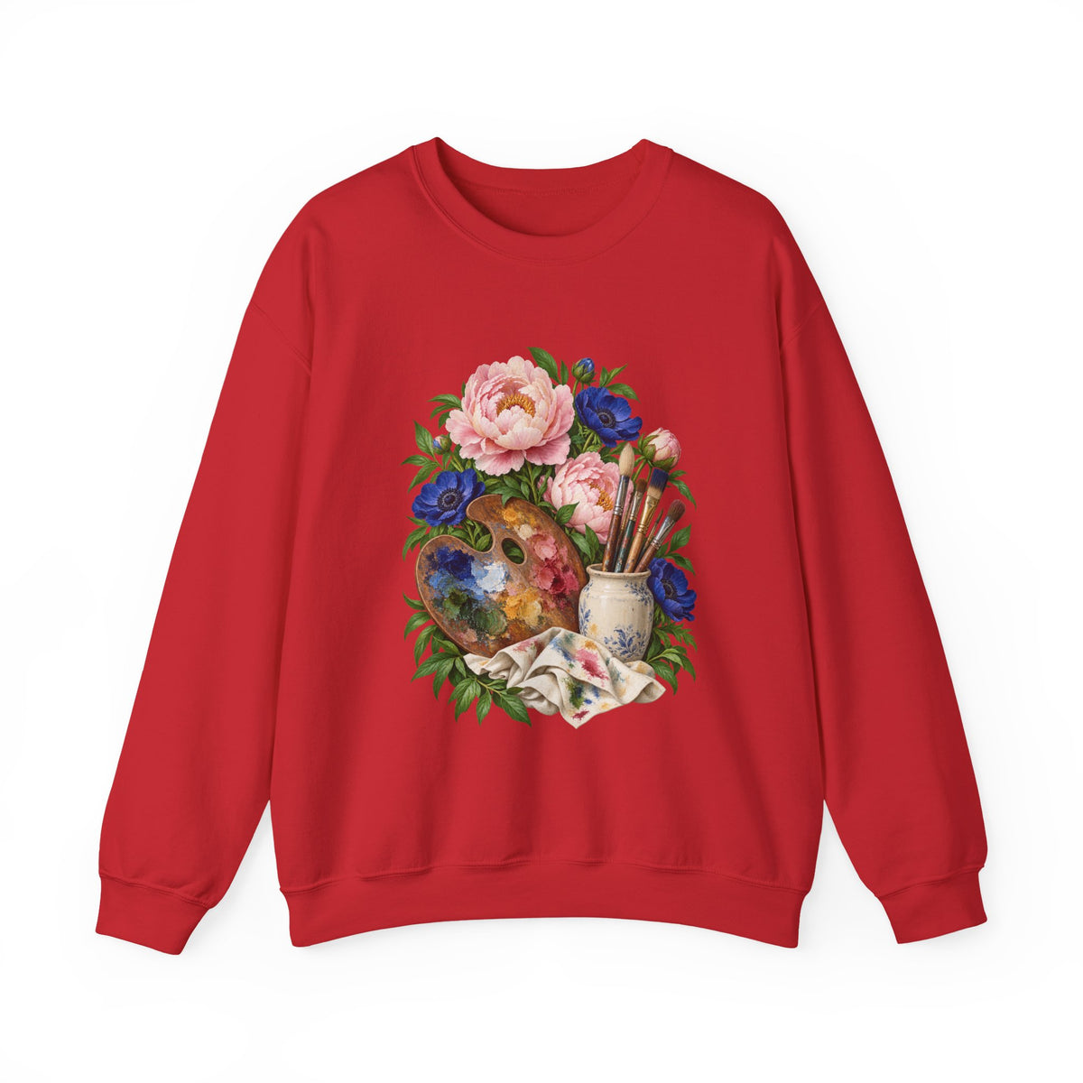 The Colors She Kept crewneck sweatshirt, a paint-covered artist palette beside a cream ceramic jar of brushes with pink peonies and deep blue flowers, image 1 of 28