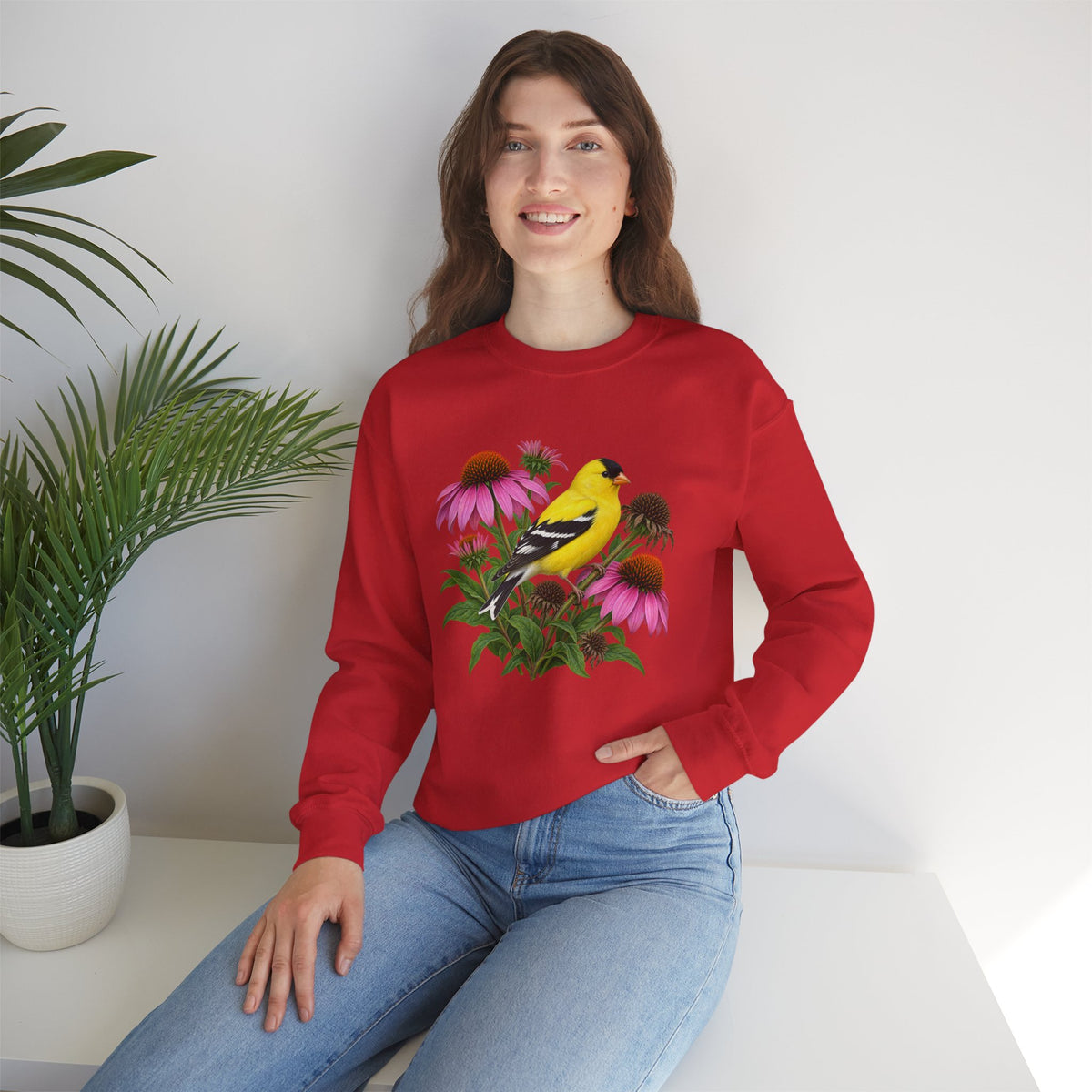 A Small Bright Thing crewneck sweatshirt, a golden-yellow American goldfinch among pink coneflowers, seed heads and green leaves, image 8 of 22