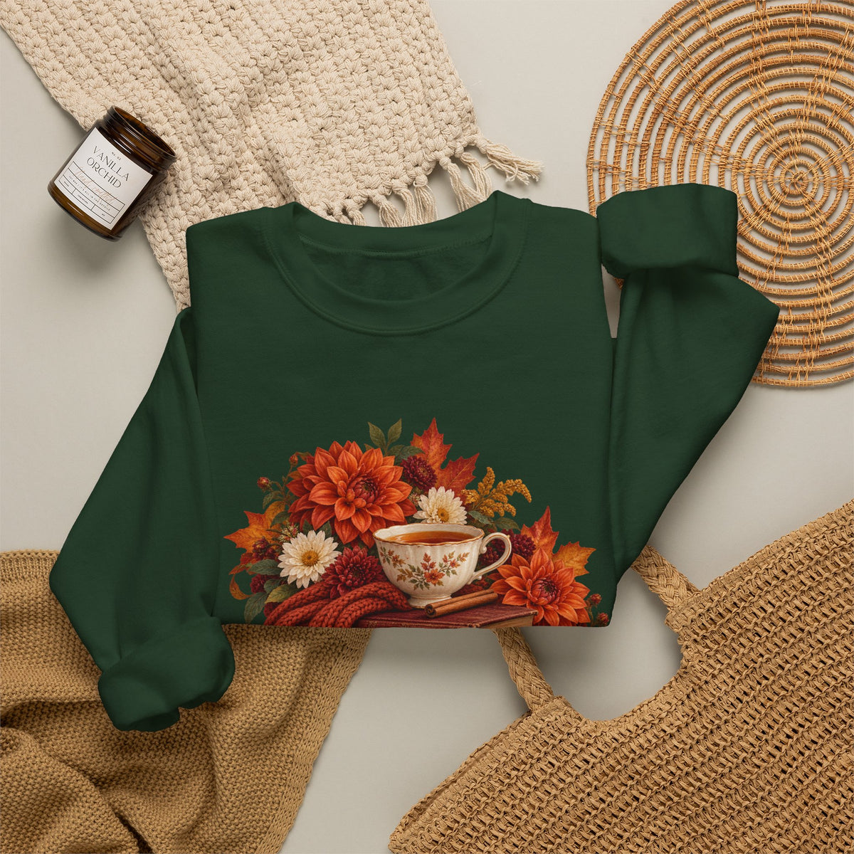 Just One More Chapter crewneck sweatshirt, a floral teacup resting on a stack of vintage books with pears, autumn flowers and a rust-colored scarf, image 12 of 14