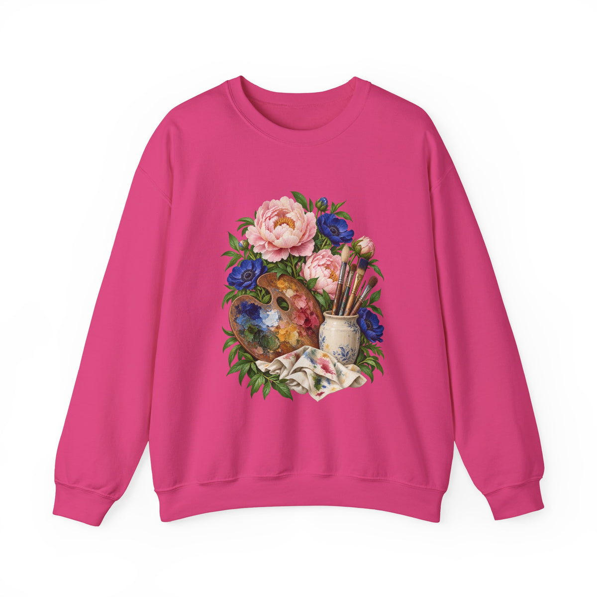 The Colors She Kept crewneck sweatshirt, a paint-covered artist palette beside a cream ceramic jar of brushes with pink peonies and deep blue flowers, image 2 of 28