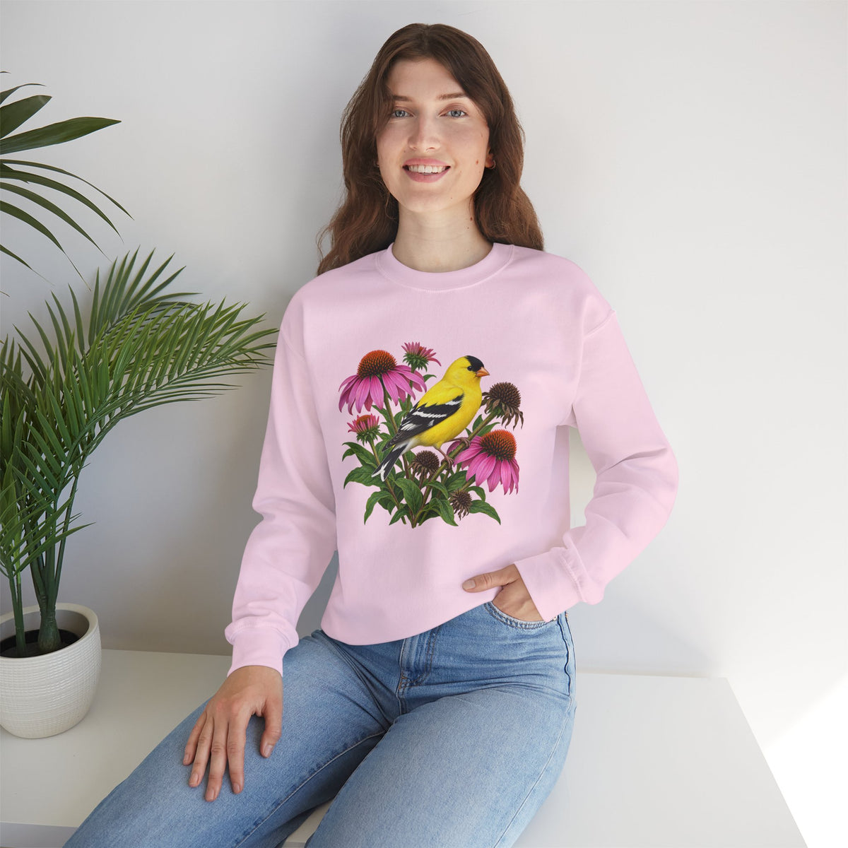 A Small Bright Thing crewneck sweatshirt, a golden-yellow American goldfinch among pink coneflowers, seed heads and green leaves, image 21 of 22