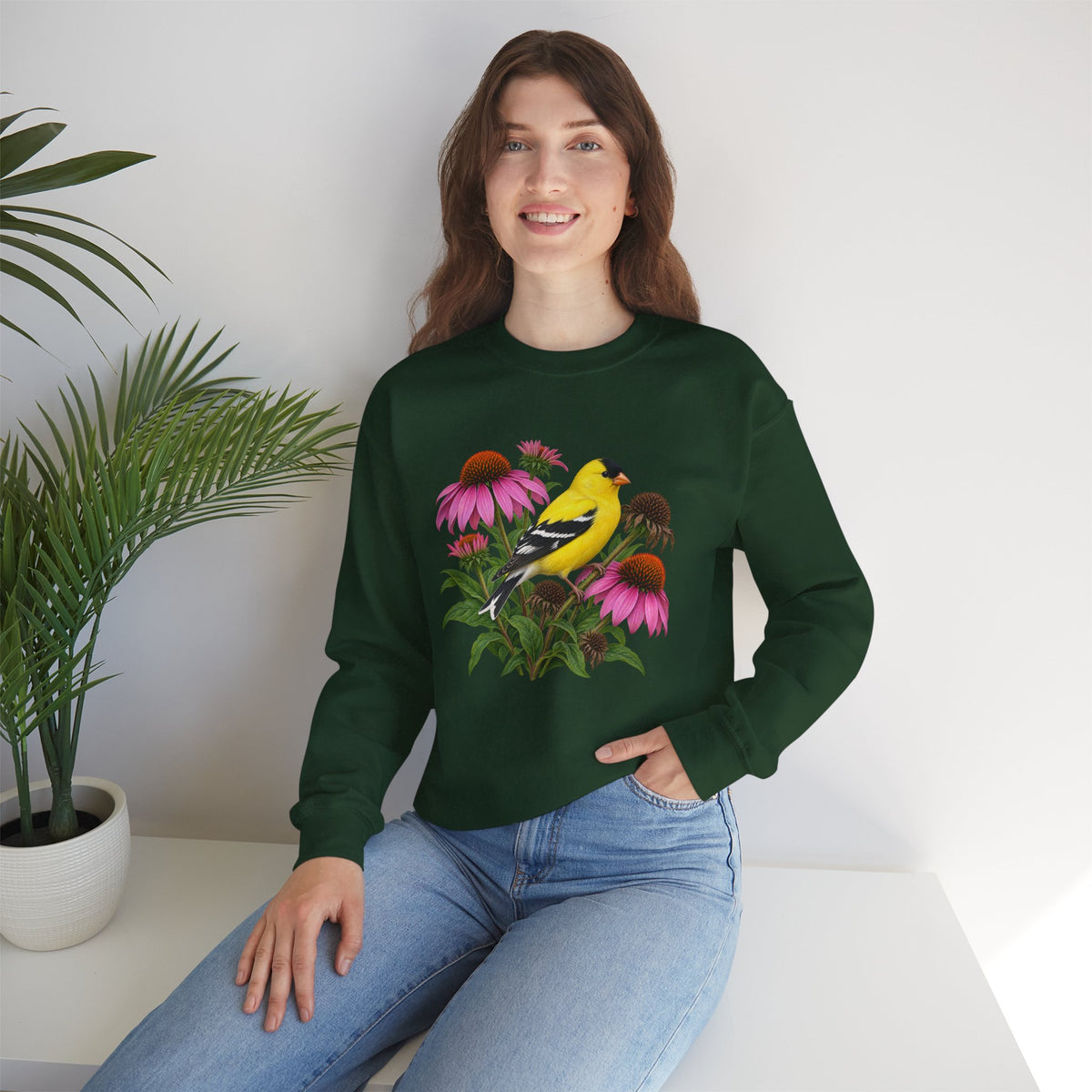 A Small Bright Thing crewneck sweatshirt, a golden-yellow American goldfinch among pink coneflowers, seed heads and green leaves, image 10 of 22