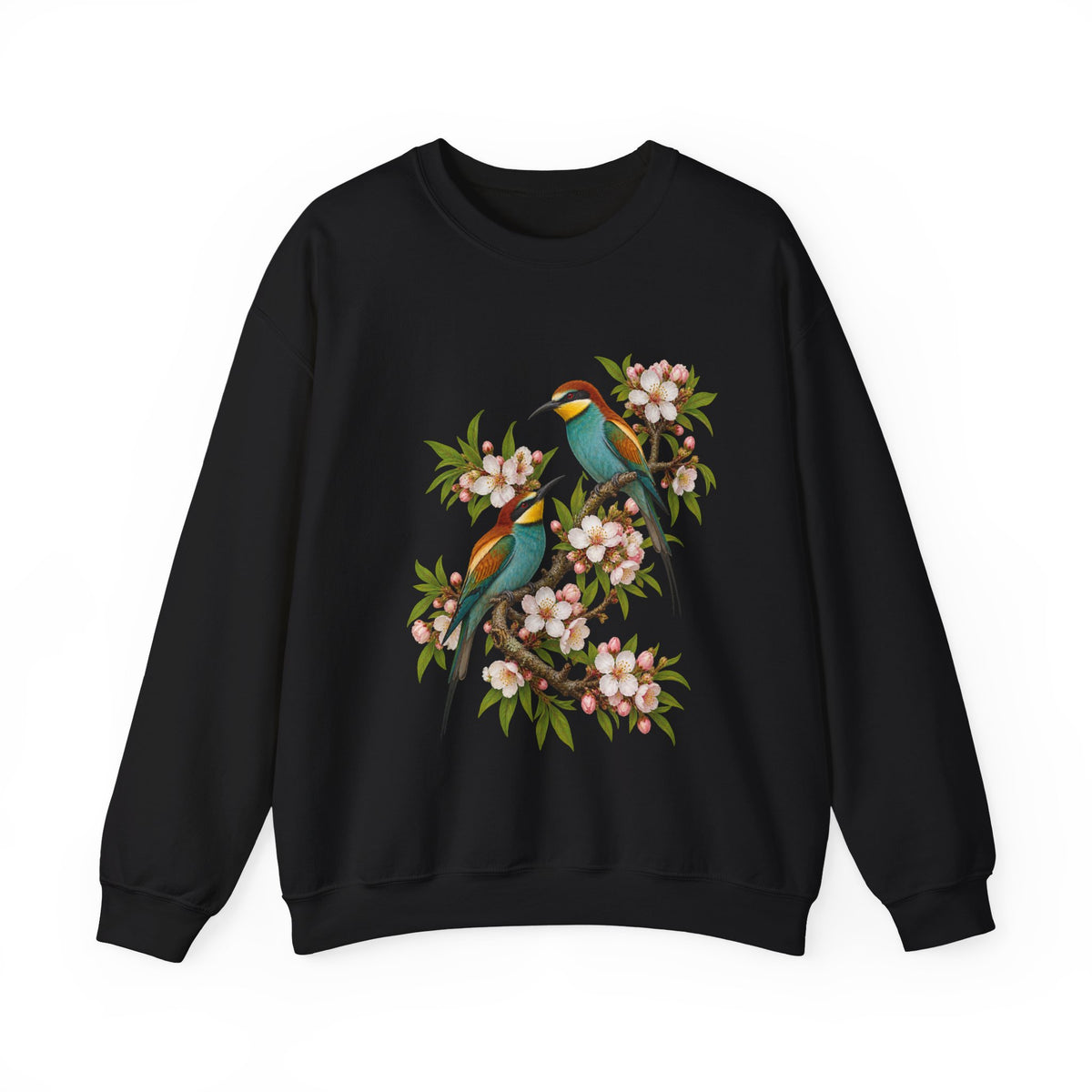 The Scenic Way Home sweatshirt — two birds with teal, golden-yellow and rust plumage perched among cream and blush blossoms, on a unisex crewneck