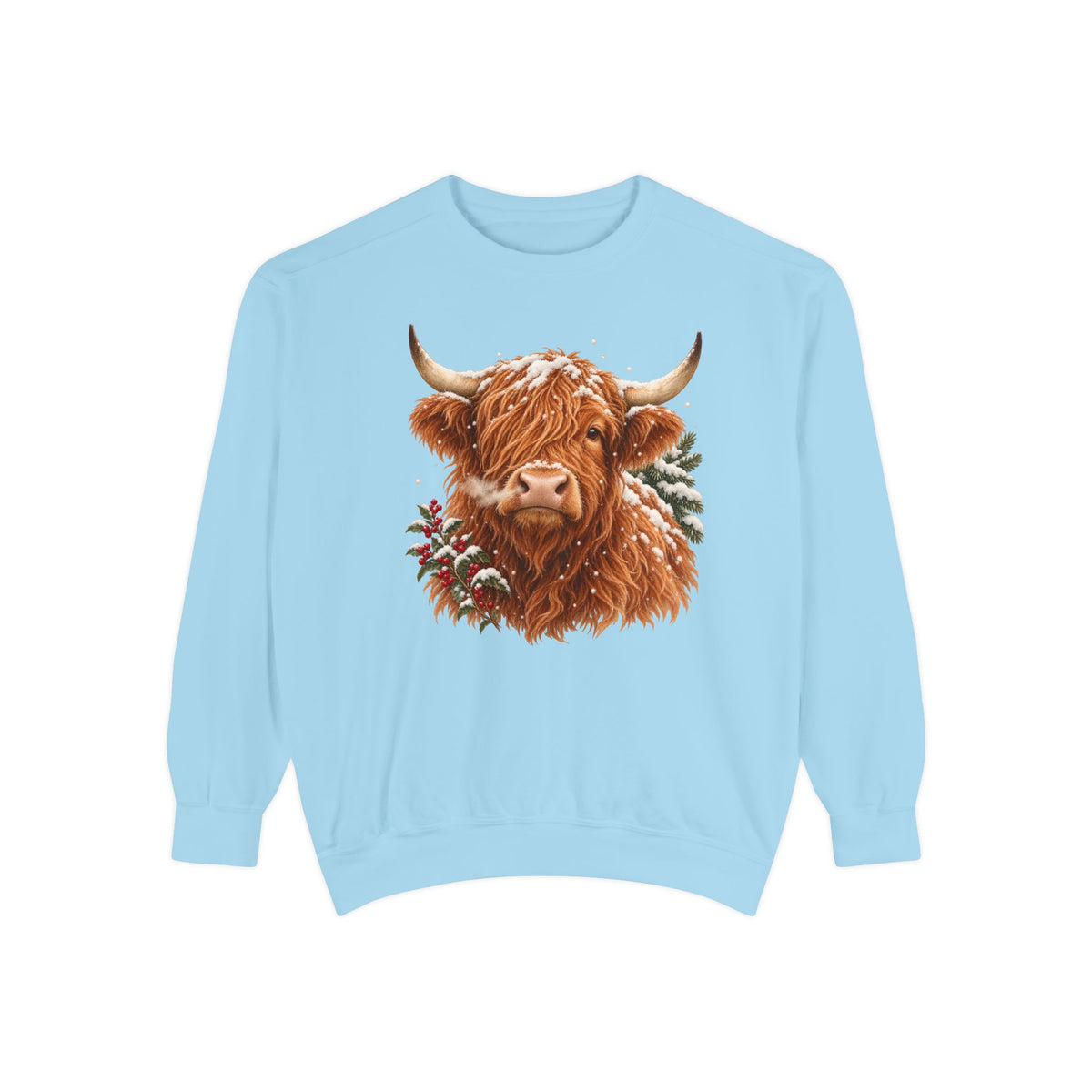 Highland cow sweatshirt in Chambray – a shaggy ginger Highland cow with snow on its fringe, a snowy pine bough and red berries, painted vintage-poster style, printed large on the chest of a Comfort Colors crewneck