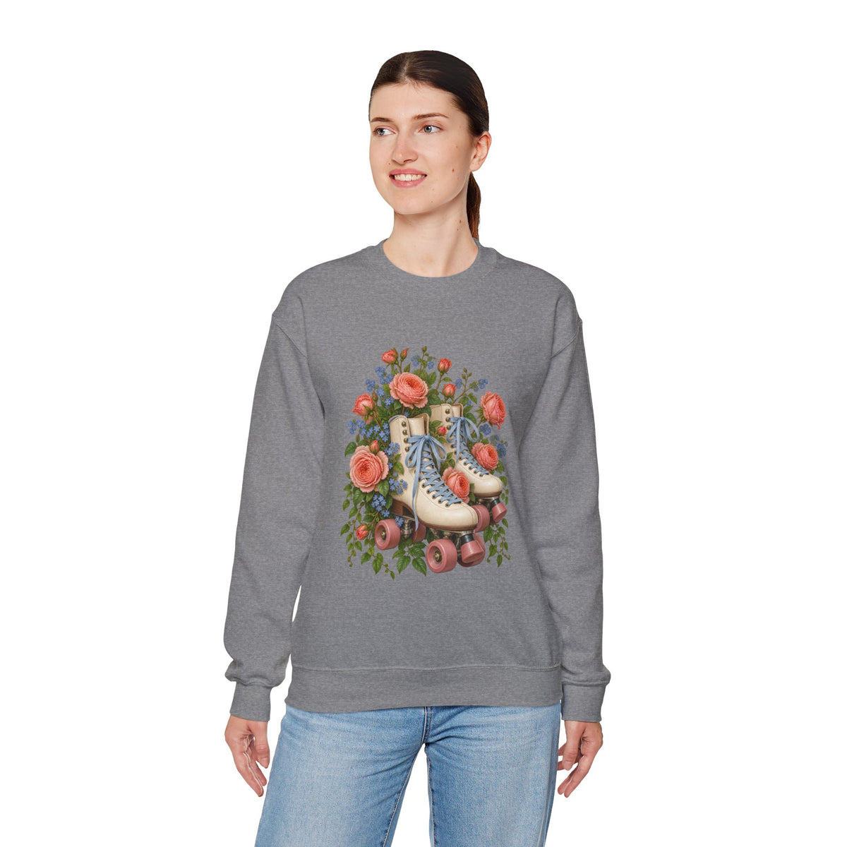 She Still Rolls crewneck sweatshirt, cream roller skates with blue laces and dusty pink wheels among coral roses, small blue flowers and trailing greenery, image 20 of 21