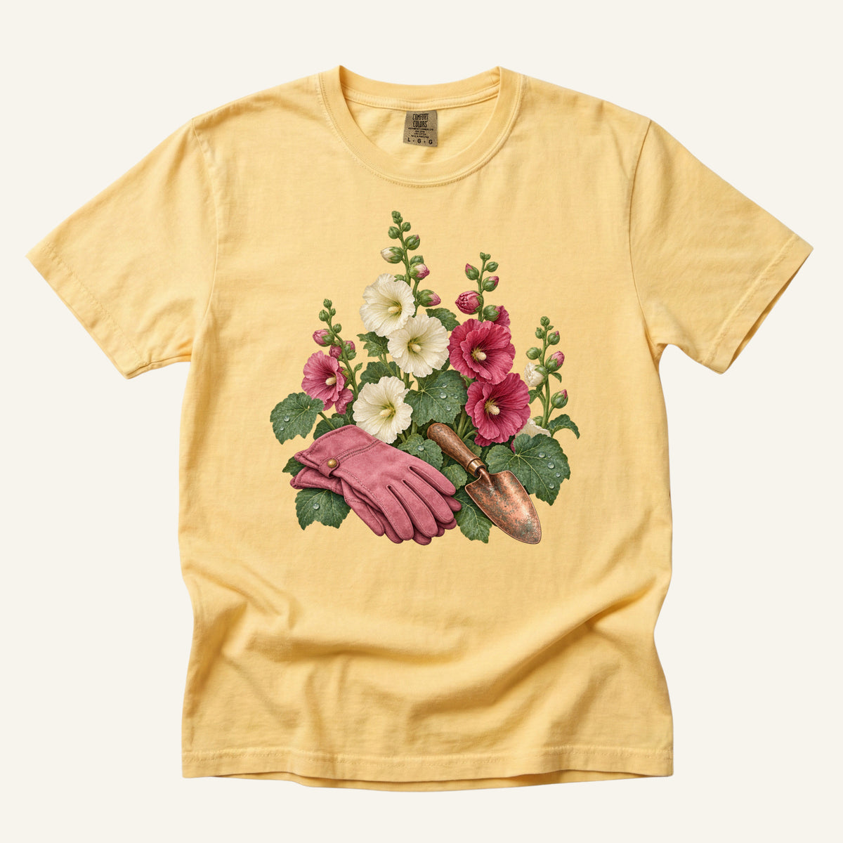 Gardening T-Shirt in Butter — cottage garden hollyhocks and hand trowel