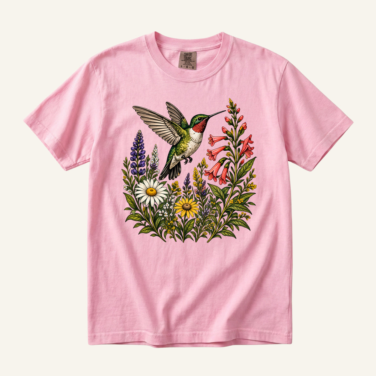 A Moment on Wings tee in Blossom, a hummingbird with red flowers and daisies on soft pink