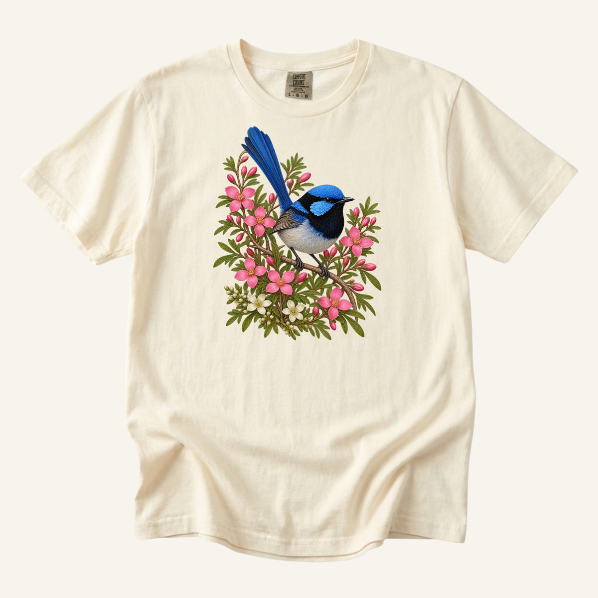 Small blue and black bird with an upright tail among pink blossoms and cream flowers, printed on an Ivory Comfort Colors 1717 unisex t-shirt