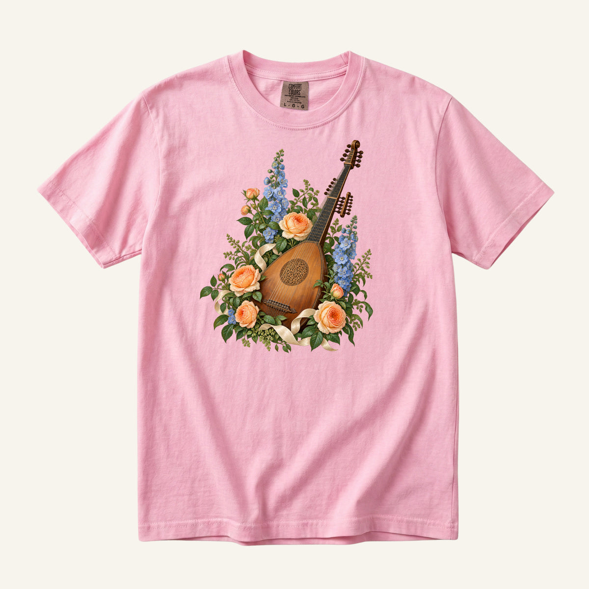 Vintage wooden lute with a carved rose sound hole among apricot roses and tall blue blossoms, printed on a Blossom pink Comfort Colors 1717 unisex t-shirt