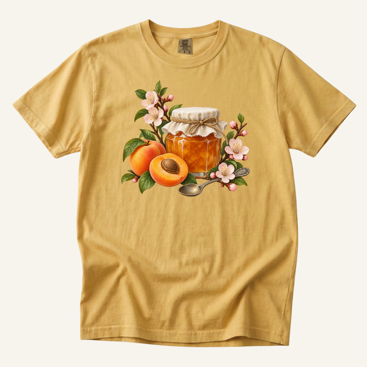Apricot Jam & Blossoms T-Shirt in Mustard — a jar of golden jam with whole and halved apricots, pink blossoms and an antique spoon