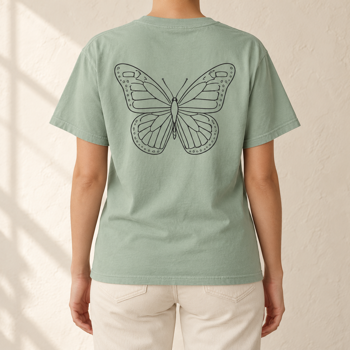 Monarch Butterfly Front and Back T-Shirt in Bay sage green, back view - line-art monarch on a garment-dyed Comfort Colors tee