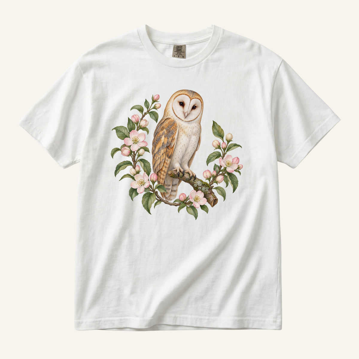 Barn Owl T-Shirt in White — a barn owl with heart-shaped face among flowers on garment-dyed cotton