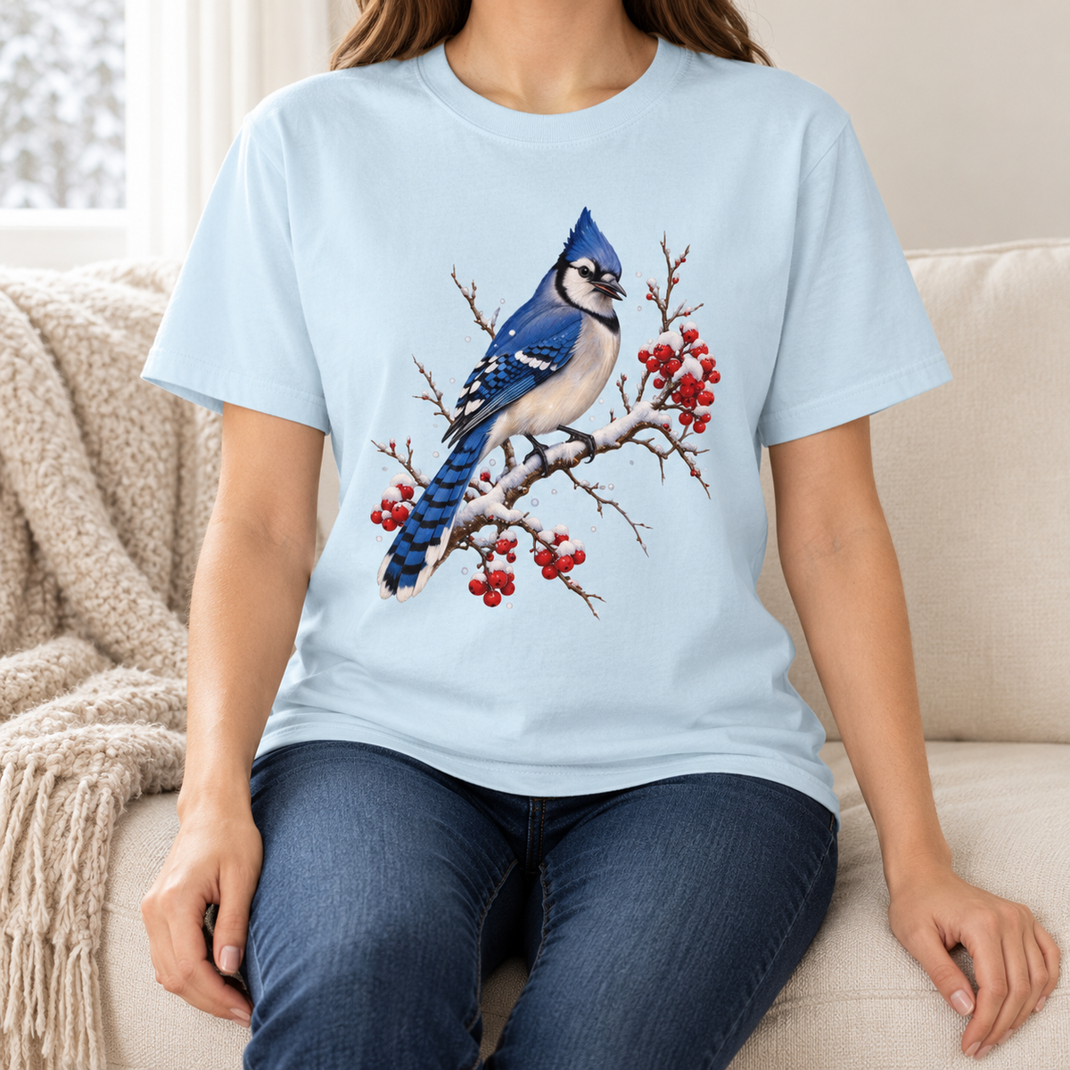 Editorial photo of the blue jay winter t-shirt – snow-capped winterberry branch and blue jay bird printed on a garment-dyed Comfort Colors tee