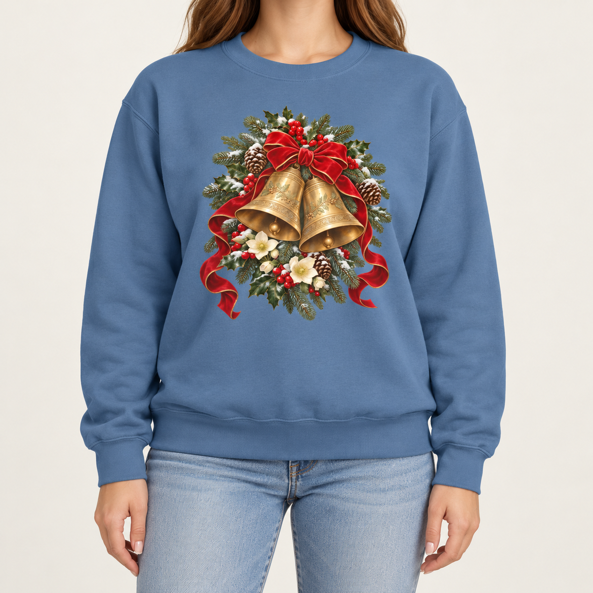 Vintage Christmas bells sweatshirt in Blue Jean – two golden bells with a red velvet bow among snowy pine, holly, pinecones and hellebores, printed large on the chest of a Comfort Colors crewneck