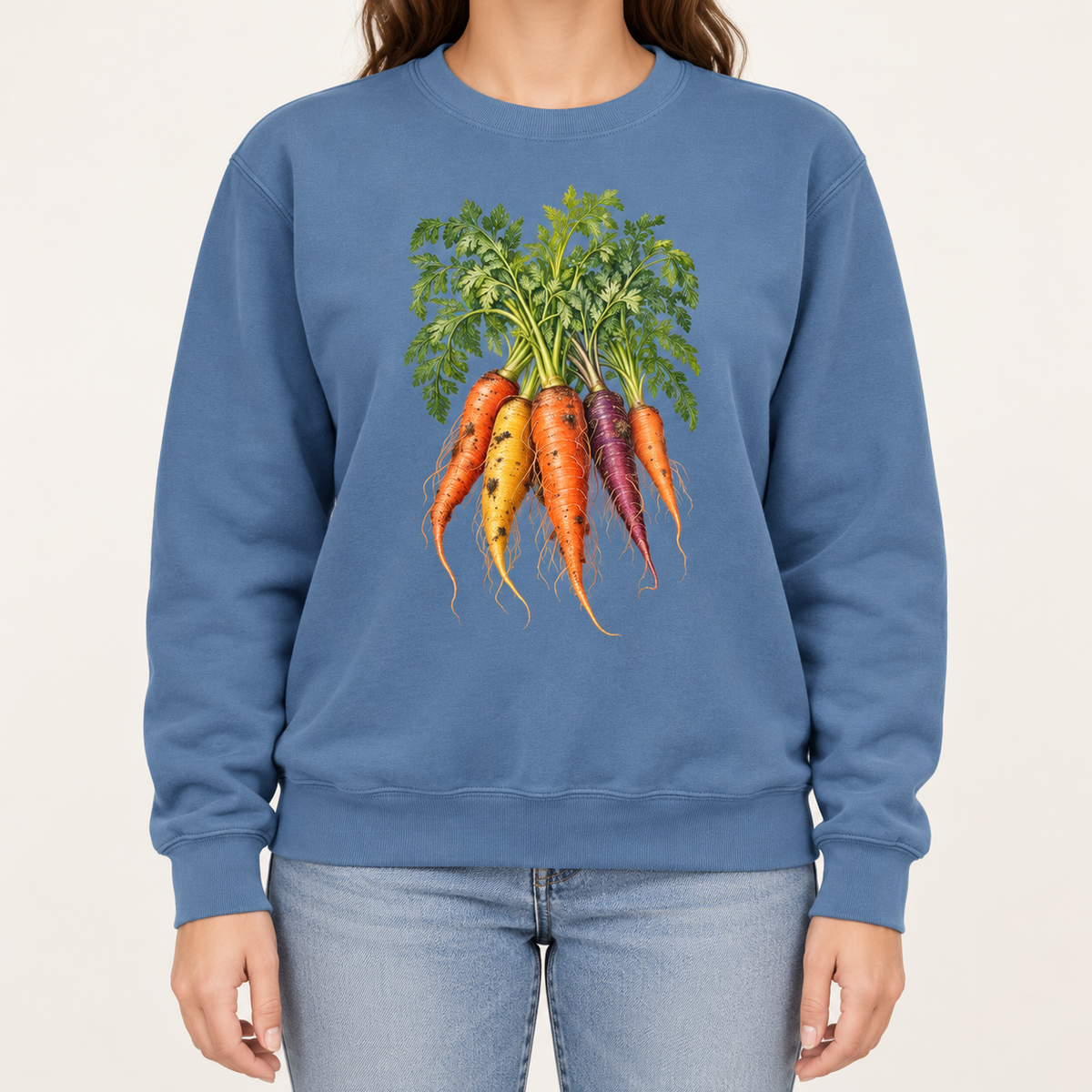 Heirloom carrot sweatshirt in Blue Jean – orange, gold and purple rainbow carrots with feathery green tops, printed large on the chest of a Comfort Colors crewneck