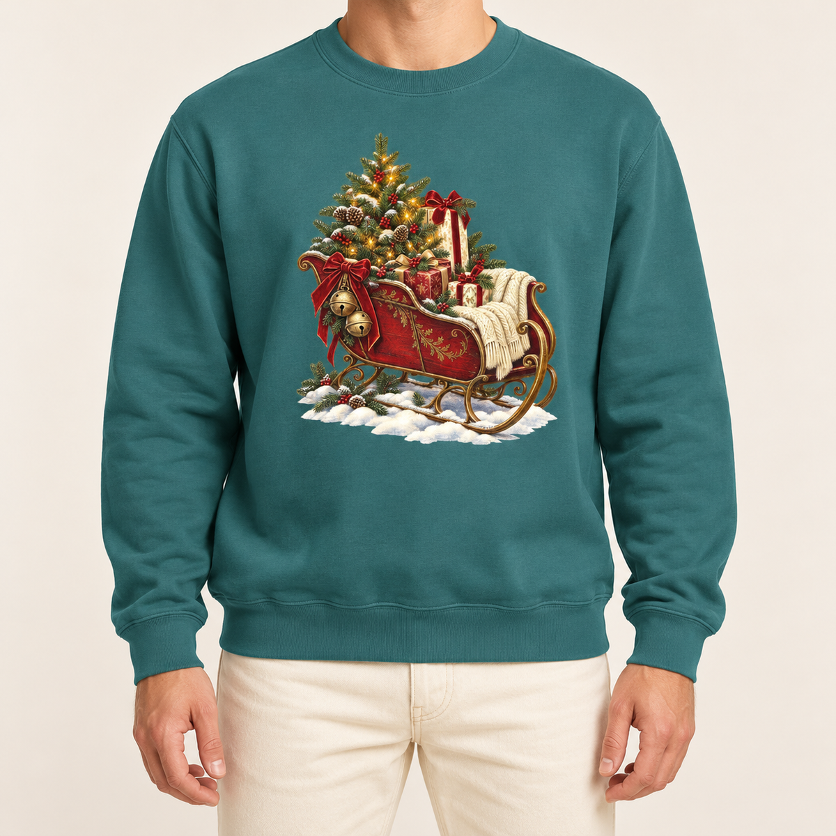 Vintage Christmas sleigh sweatshirt in Blue Spruce – a cranberry-red sleigh with gold trim heaped with fresh-cut fir and hung with golden bells, printed large on the chest of a Comfort Colors crewneck