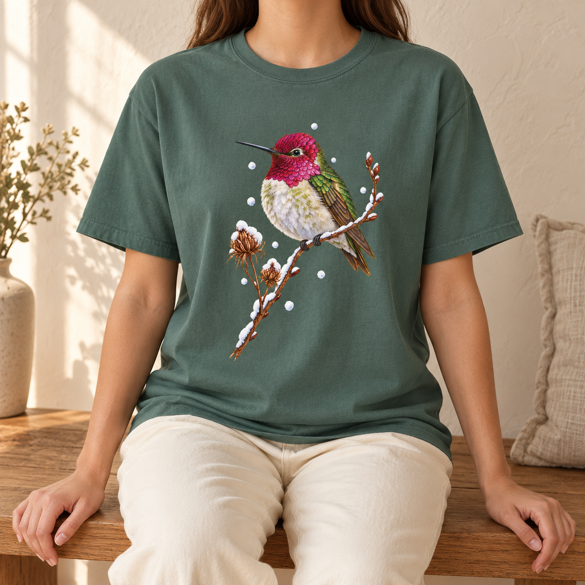 Winter Hummingbird T-Shirt in Blue Spruce - a watercolor Anna's hummingbird with a magenta head perched on a snowy twig, printed on a garment-dyed Comfort Colors 1717 cotton tee