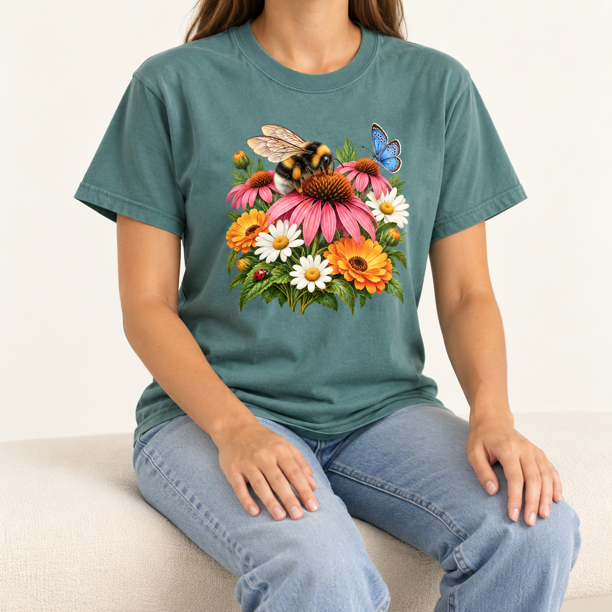 The Blue Spruce Pollinator Garden tee worn, showing the bumblebee and coneflower print centered on the chest