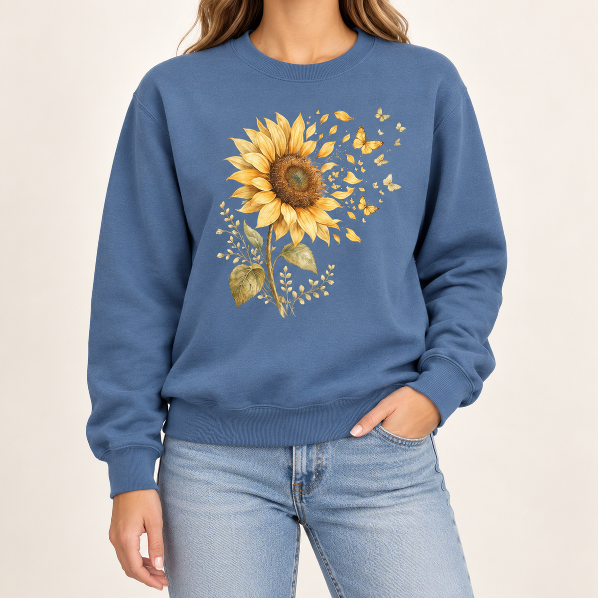 Sunflower butterfly sweatshirt – a golden watercolor sunflower letting go of its petals as small gold butterflies, printed large on the chest of a garment-dyed Comfort Colors crewneck