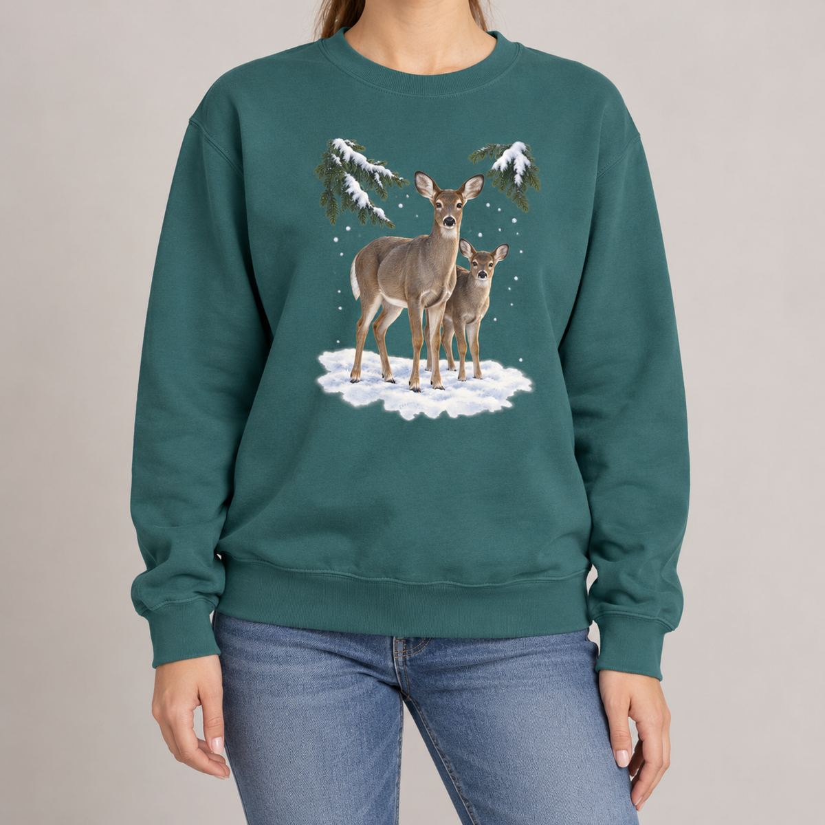 Winter Deer sweatshirt in Blue Spruce, worn: a doe and her fawn in the snow beneath spruce boughs, watercolor print