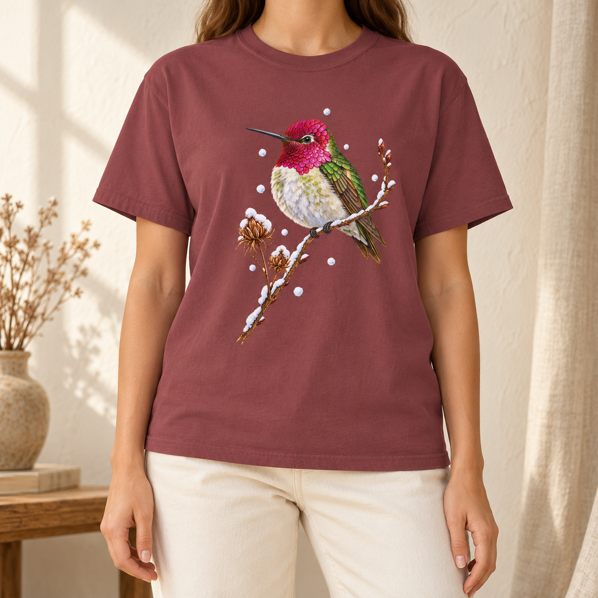 Winter Hummingbird T-Shirt in Brick - a watercolor Anna's hummingbird with a magenta head perched on a snowy twig, printed on a garment-dyed Comfort Colors 1717 cotton tee