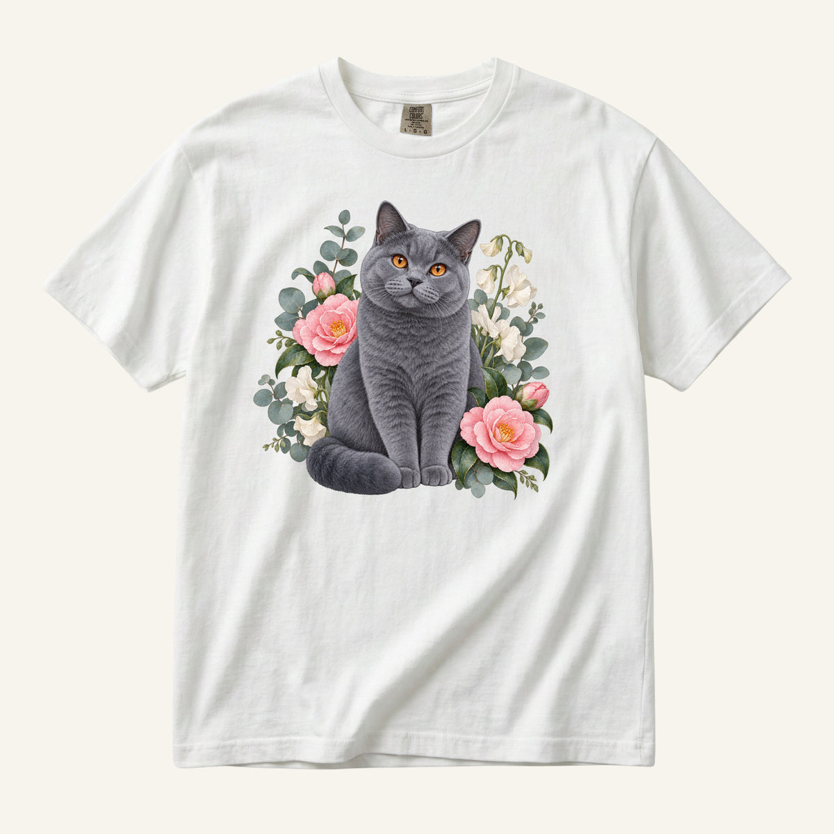 British Shorthair Cat T-Shirt in White — blue-grey cat with pink camellia blossoms watercolor design