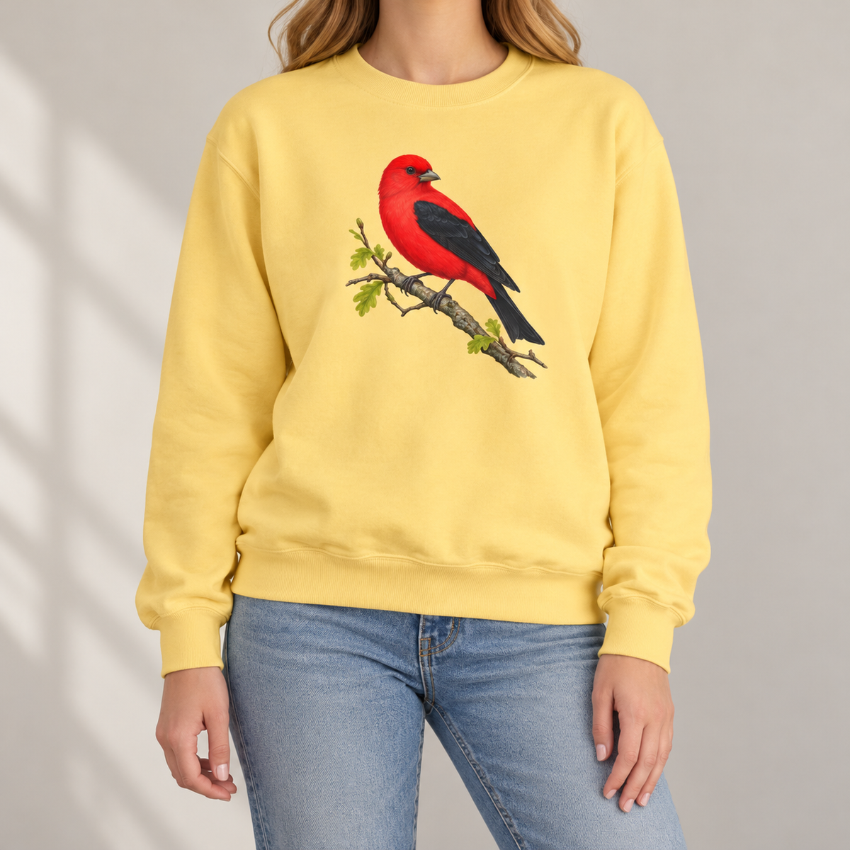 Scarlet Tanager sweatshirt in Butter — red bird with black wings on a spring oak branch, garment-dyed Comfort Colors crewneck