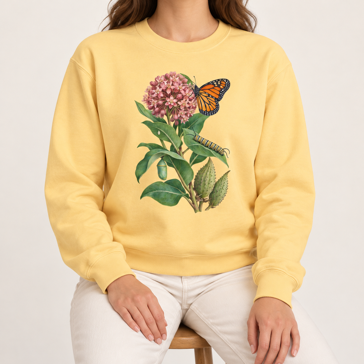 Milkweed and monarch life cycle sweatshirt in Butter, pink milkweed and orange monarch on a soft yellow Comfort Colors crewneck