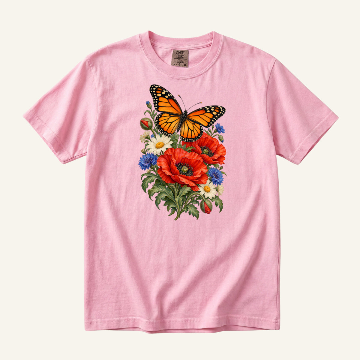 Red Poppies and Butterfly T-Shirt in Blossom — pale pink, with the orange-and-black butterfly above red poppies and cream daisies