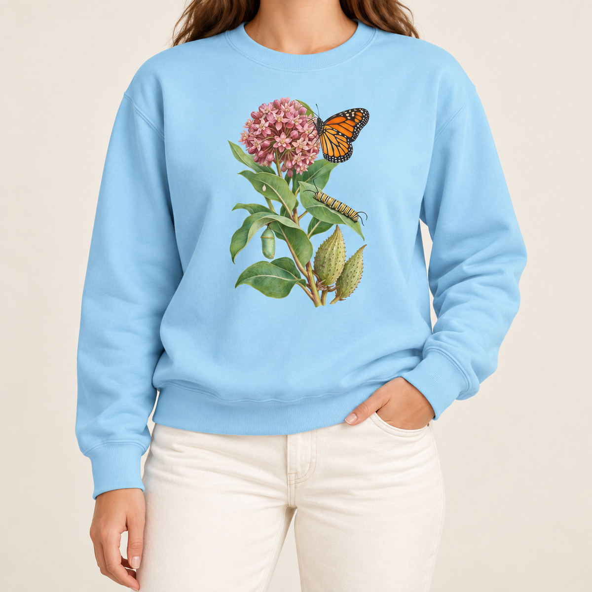 Milkweed and monarch life cycle sweatshirt in Chambray – pink milkweed with a monarch butterfly, caterpillar, chrysalis and seed pods printed large on the chest of a Comfort Colors crewneck