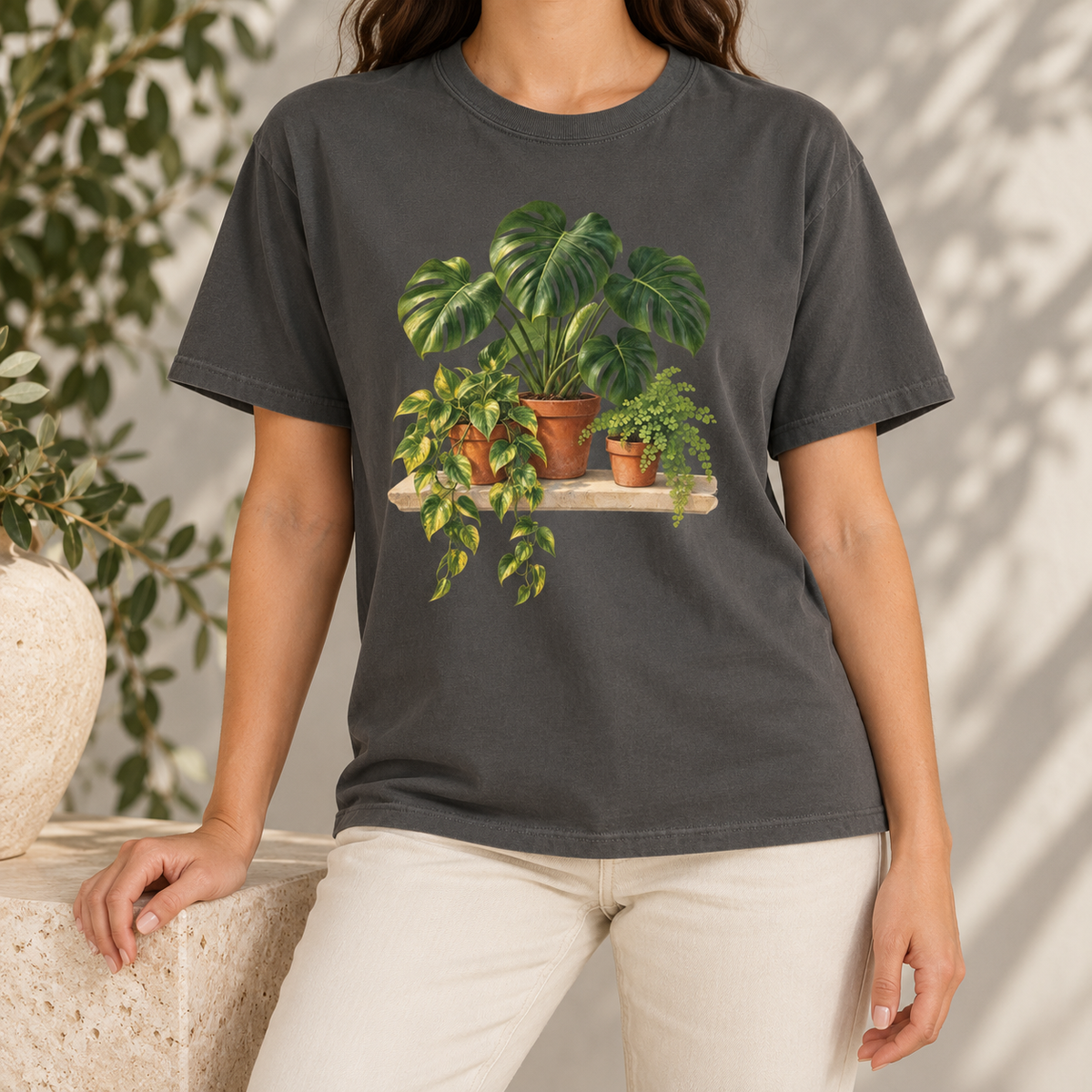 Houseplant t-shirt in Pepper – the charcoal garment-dyed Comfort Colors tee in studio light, potted plant print on the chest