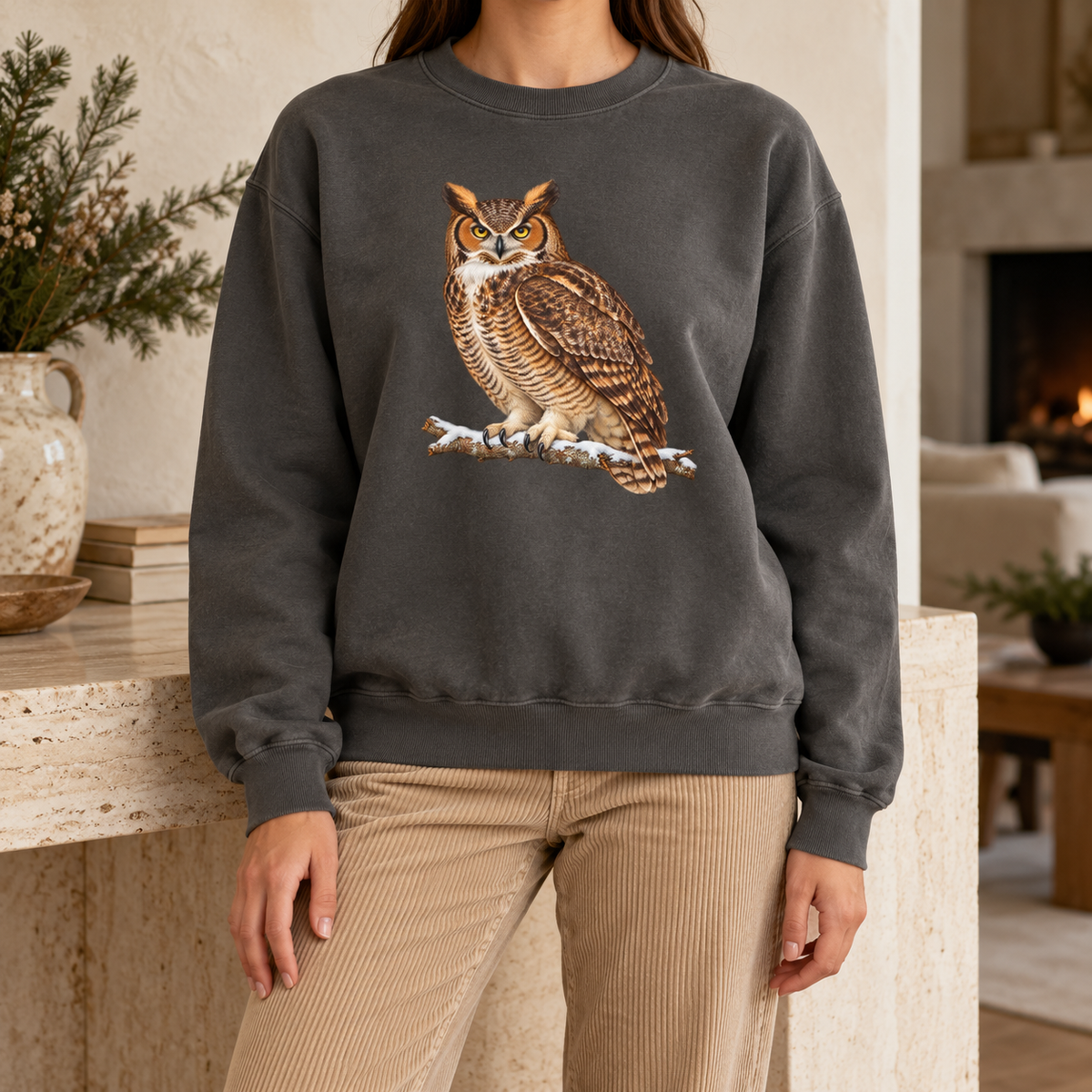 Great horned owl sweatshirt in Pepper in soft winter light – the owl's yellow eyes and snowy branch on a washed charcoal Comfort Colors crewneck