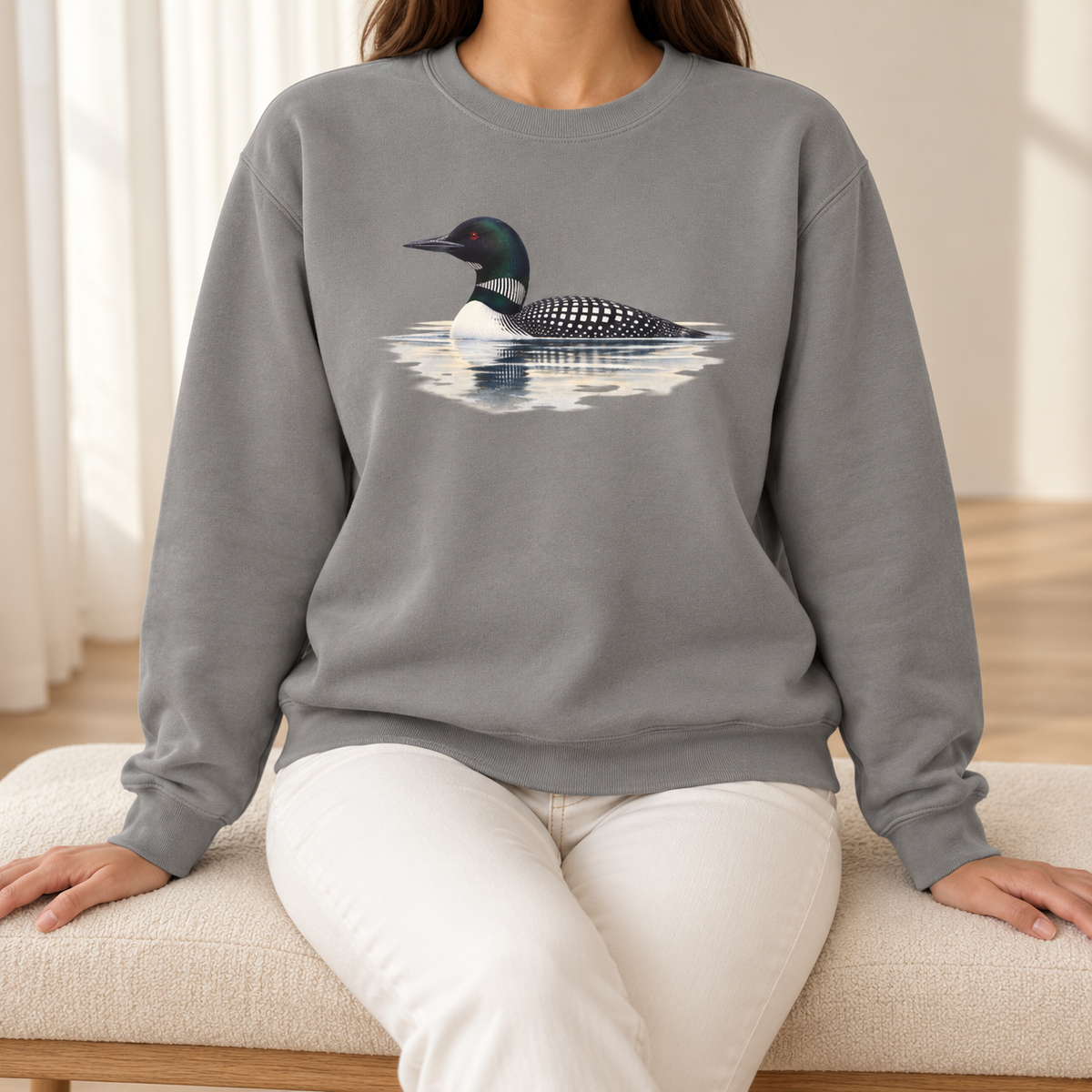Common Loon Sweatshirt in Grey - watercolor loon on a misty lake printed on a heathered grey Comfort Colors crewneck, worn by a woman