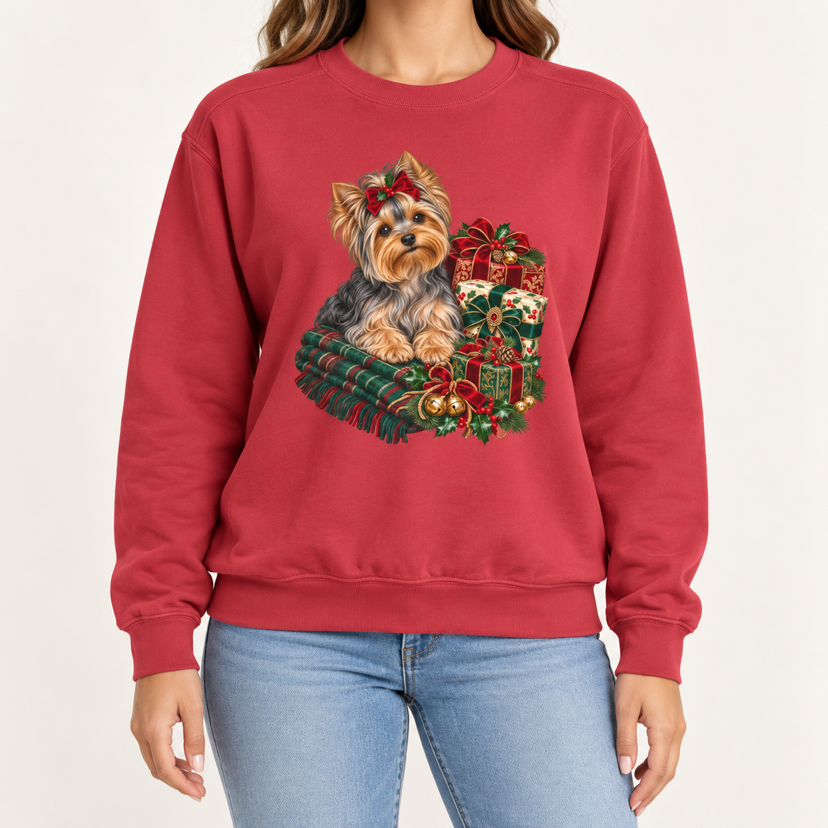 Yorkie Christmas sweatshirt in Crimson – a Yorkshire terrier with a red bow on a tartan blanket beside wrapped Christmas presents, printed large on the chest of a Comfort Colors crewneck